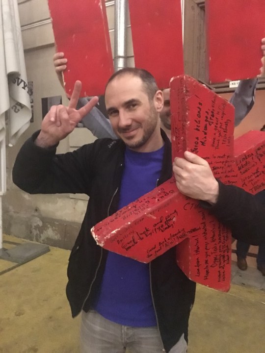 Holding an old, small TEDx sign